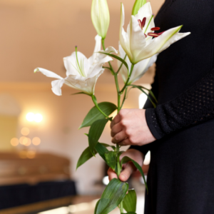 holding lillies at funeral